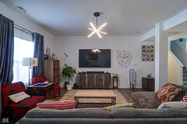 living room with a chandelier and wood-type flooring