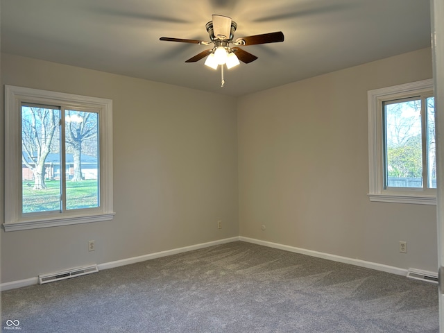 spare room with ceiling fan and carpet