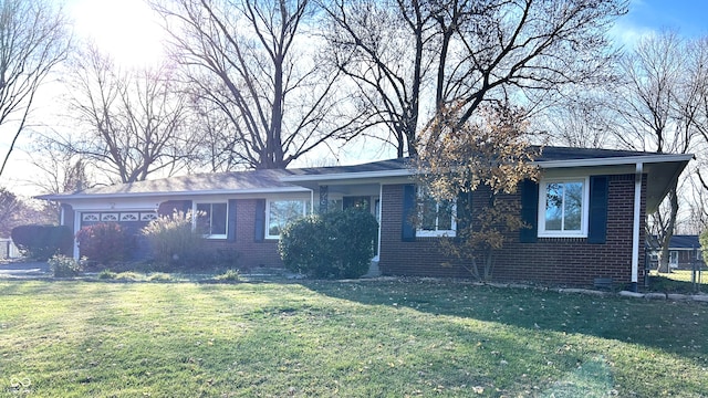 single story home featuring a front yard and a garage