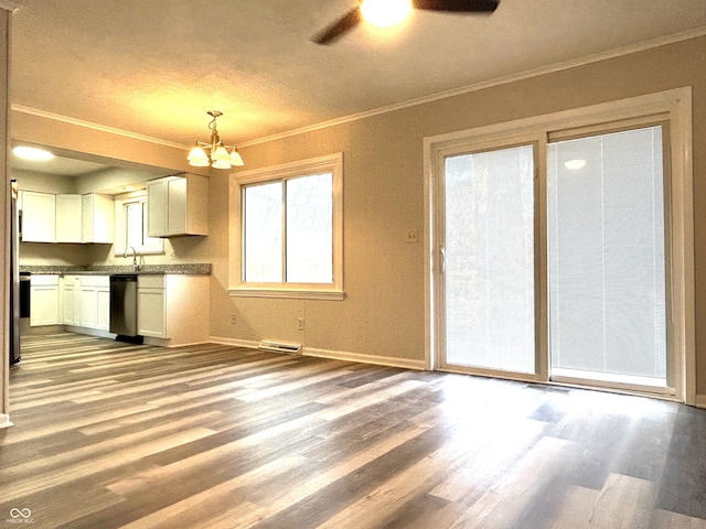 kitchen with white cabinets, decorative light fixtures, stainless steel dishwasher, and light hardwood / wood-style floors