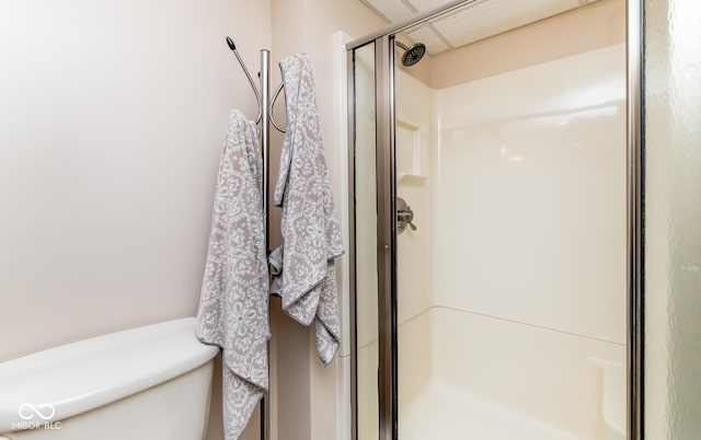 bathroom featuring a shower with door