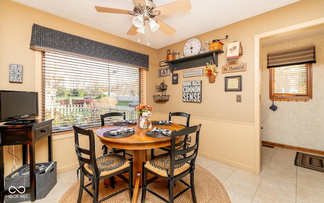 tiled dining space with ceiling fan