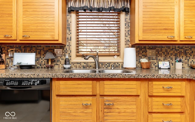 kitchen with sink, black dishwasher, and backsplash