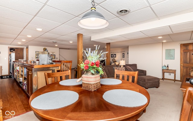 dining area featuring a drop ceiling