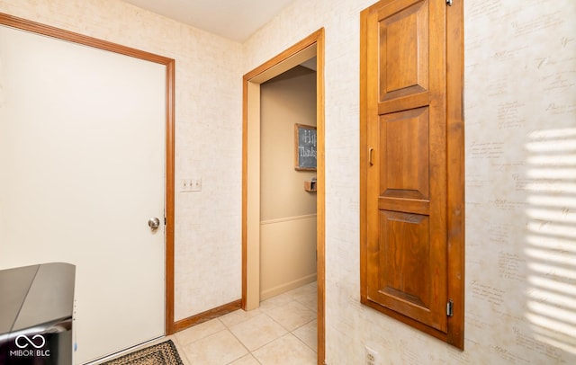 hall with light tile patterned floors