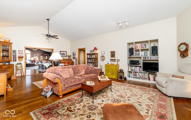 living room with ceiling fan, hardwood / wood-style floors, and vaulted ceiling