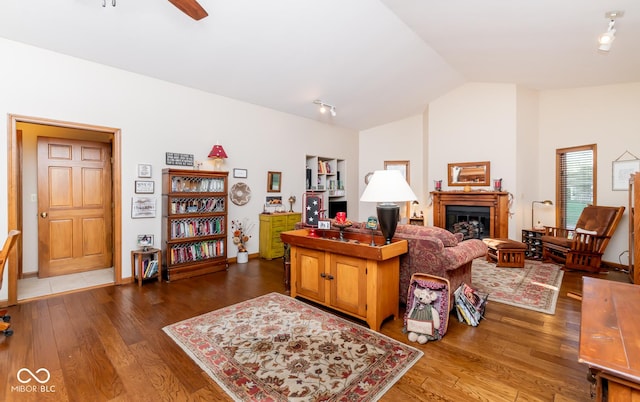 living room featuring lofted ceiling, ceiling fan, and dark hardwood / wood-style floors