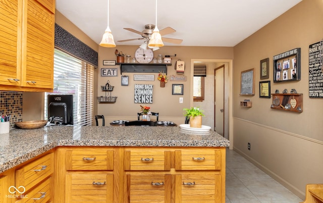 kitchen featuring ceiling fan, light tile patterned floors, and decorative backsplash