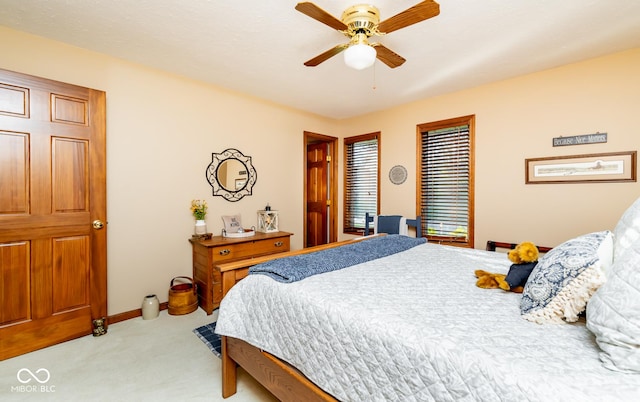 bedroom featuring ceiling fan and light carpet