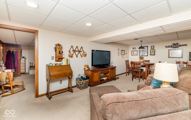 living room featuring light carpet and a drop ceiling