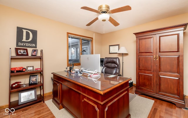 office area with light wood-type flooring and ceiling fan