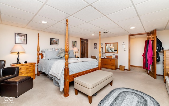 carpeted bedroom with a paneled ceiling