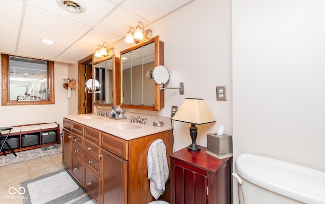 bathroom featuring toilet, a drop ceiling, tile patterned floors, and vanity