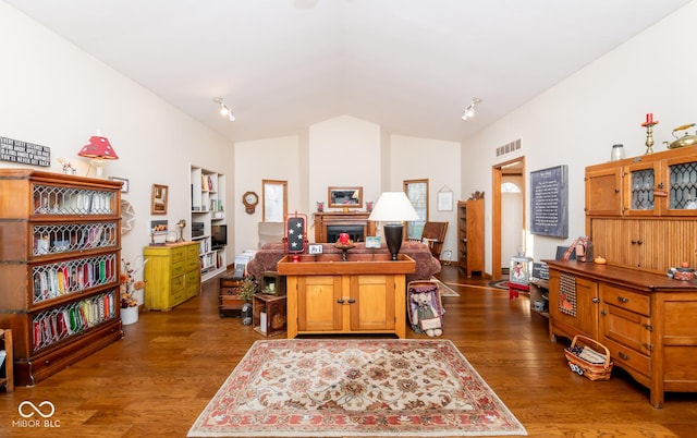 office with lofted ceiling and dark hardwood / wood-style flooring