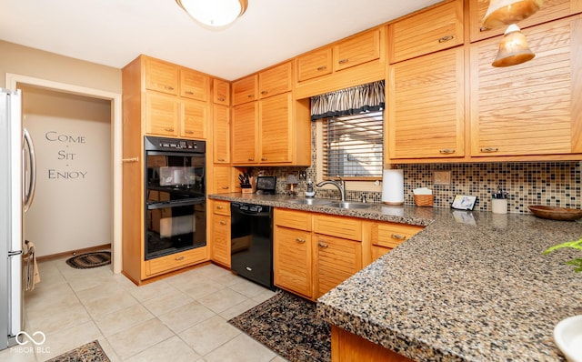 kitchen featuring sink, light tile patterned flooring, decorative backsplash, and black appliances