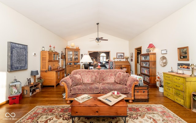 living room featuring ceiling fan, dark hardwood / wood-style flooring, and vaulted ceiling