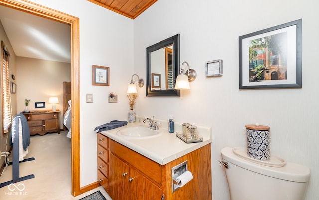 bathroom featuring toilet, wood ceiling, and vanity