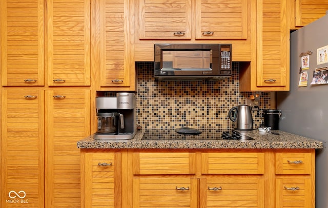 kitchen with black appliances and decorative backsplash