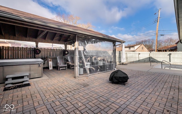 view of patio / terrace with a hot tub