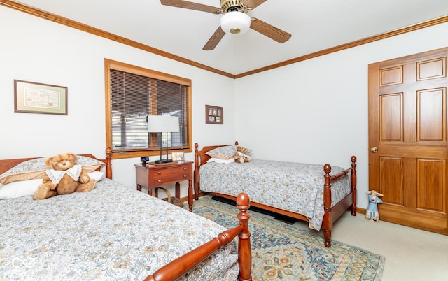 bedroom with carpet floors, ceiling fan, and crown molding