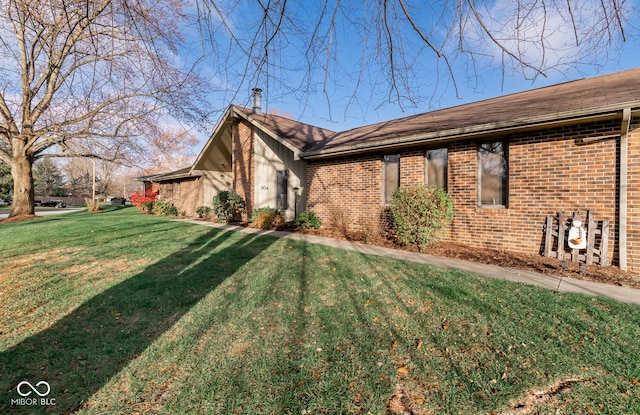 view of side of property with a yard