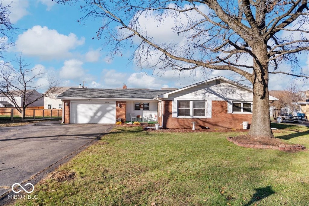 single story home with a front lawn and a garage