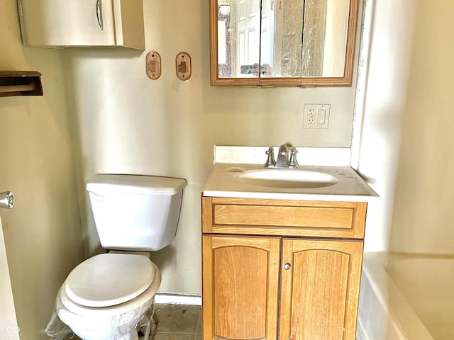 bathroom with vanity, toilet, and tile patterned floors