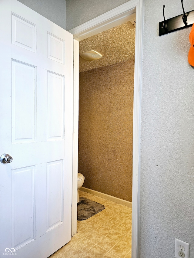 bathroom featuring tile patterned floors and toilet