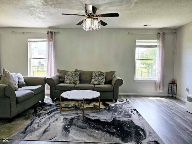 living room with plenty of natural light, a textured ceiling, and hardwood / wood-style flooring