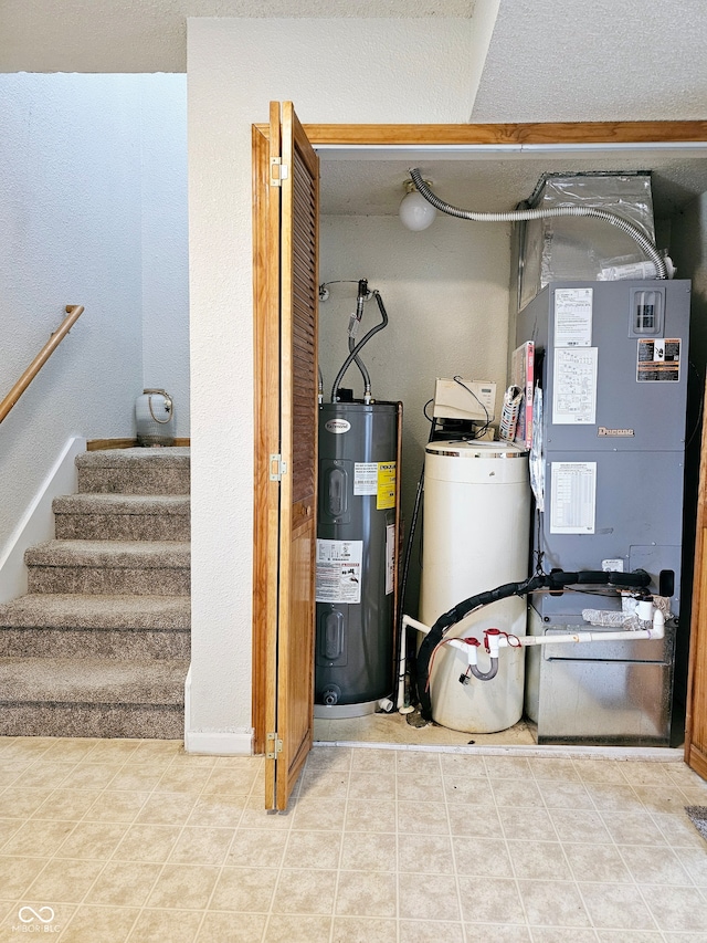 utilities featuring heating unit, electric water heater, and water heater