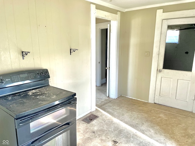 kitchen with crown molding, wood walls, and black electric range