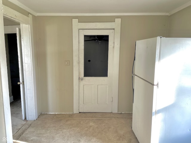 interior space featuring white refrigerator and crown molding