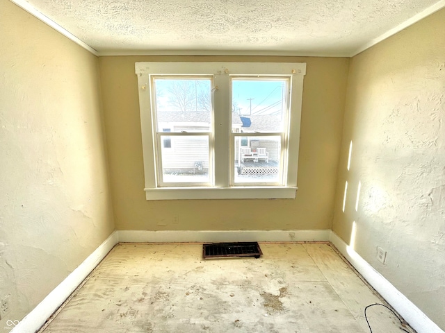 spare room with a textured ceiling