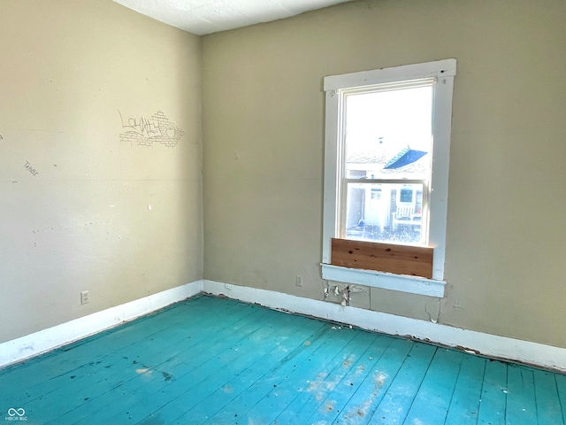 unfurnished room featuring hardwood / wood-style floors and a healthy amount of sunlight