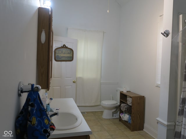 bathroom with walk in shower, vanity, and toilet