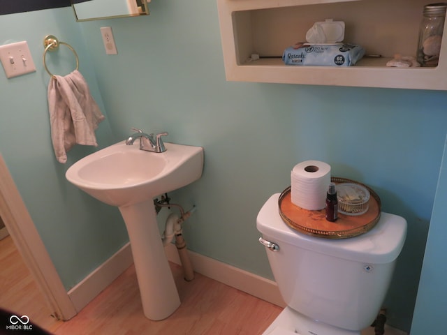 bathroom featuring hardwood / wood-style floors and toilet