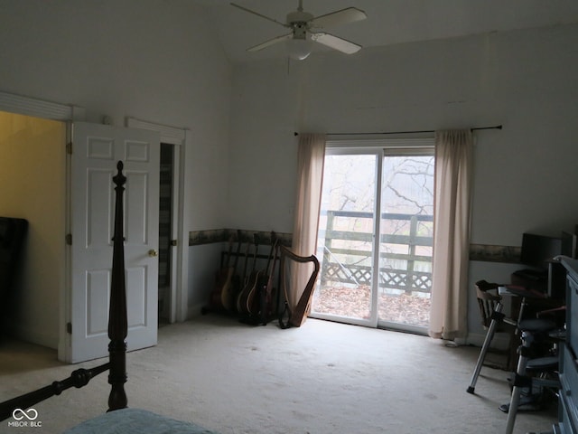 interior space featuring access to outside, ceiling fan, light colored carpet, and vaulted ceiling