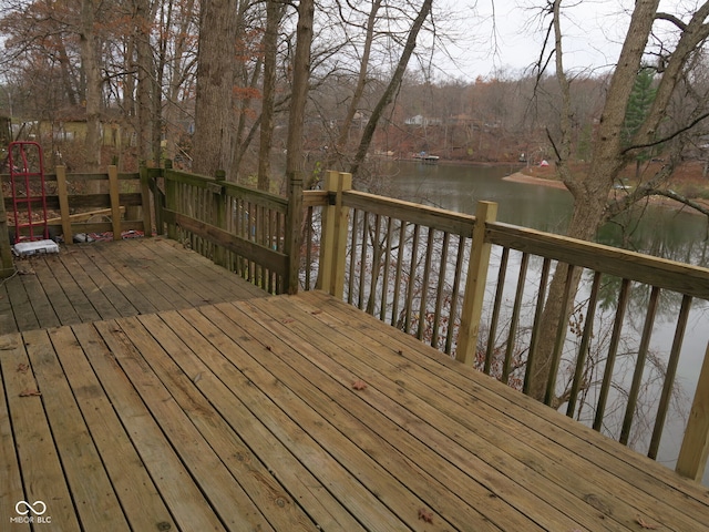 wooden terrace featuring a water view