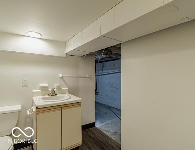 bathroom with hardwood / wood-style floors, vanity, and toilet