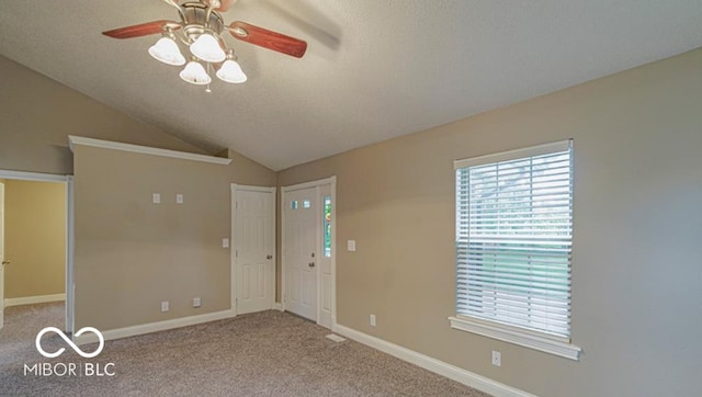 empty room featuring carpet flooring, ceiling fan, a textured ceiling, and vaulted ceiling