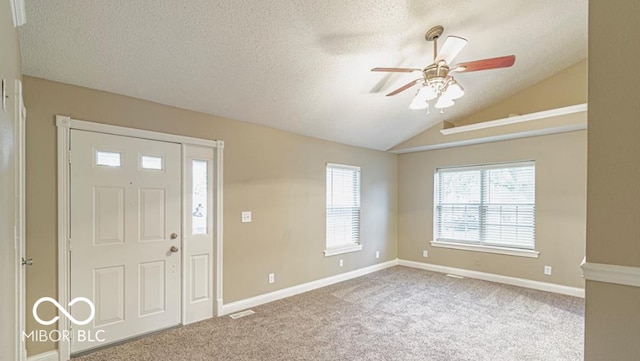 entryway featuring carpet, a textured ceiling, ceiling fan, and lofted ceiling