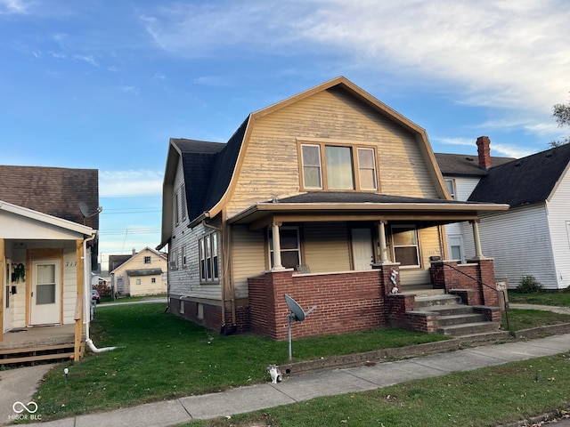 view of front of house featuring covered porch and a front lawn