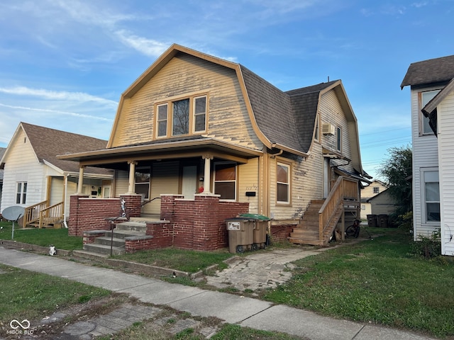 view of front of house with a front yard and a porch