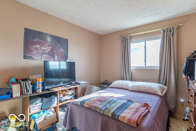 bedroom with carpet and a textured ceiling