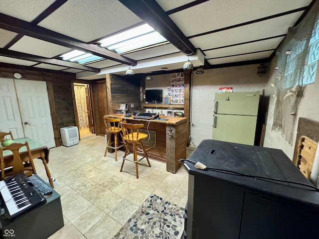 home office with wood walls and light tile patterned floors