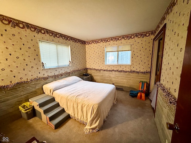 carpeted bedroom with wooden walls