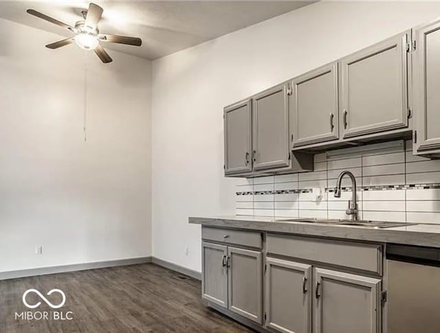 kitchen featuring dark hardwood / wood-style floors, gray cabinetry, and sink