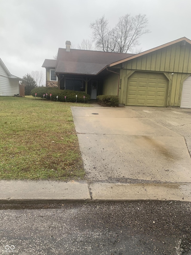 view of front facade with a front yard and a garage