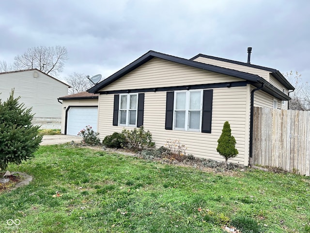 view of home's exterior featuring a garage and a lawn