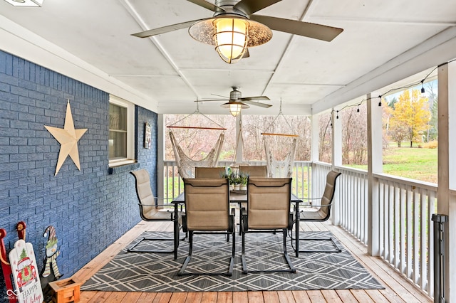 sunroom featuring ceiling fan